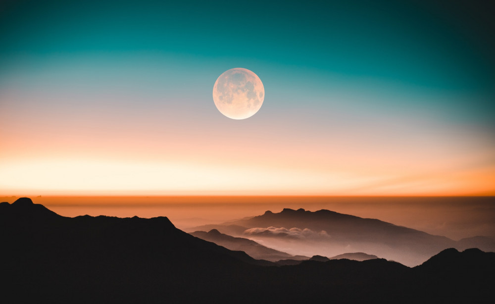 The Moon over mountain sunset