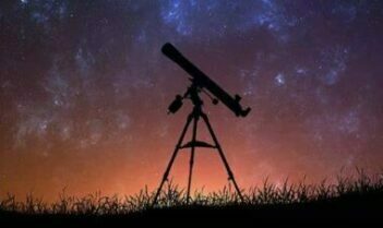 refractor telescope under a starry sky