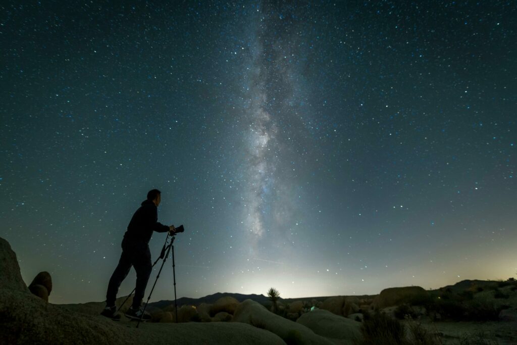 astronomy photography tips: A person with camera photographing the Milky Way