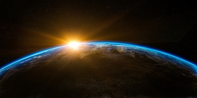Six Great Astronomy Books For 2025 - A photo of the sun appearing above the Earth's horizon from space.