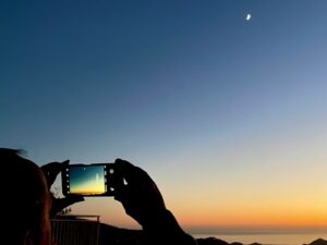 Person taking a night-sky photo with smartphone