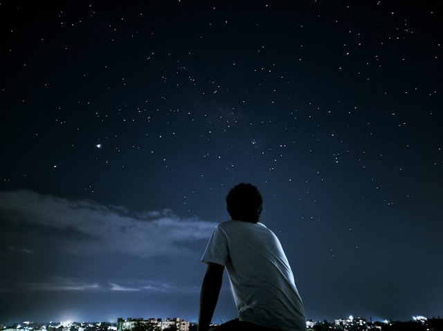how to start stargazing - person looking up at the night sky
